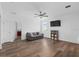Bright living room with hardwood floors, a gray sofa, a ceiling fan, and a TV on the wall at 2091 Brillante Dr, St Cloud, FL 34771