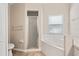 Well-lit bathroom showcasing an oval soaking tub and separate shower at 2209 Hannah Ln, Orlando, FL 32826