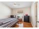 Cozy bedroom with hardwood floors, ceiling fan, window with blinds, and dresser storage at 2209 Hannah Ln, Orlando, FL 32826