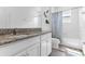 Bathroom featuring granite counters, white cabinets, a bathtub and modern fixtures at 2246 Rush Bay Way, Orlando, FL 32824