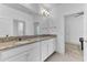 Bright bathroom featuring granite counters with double sinks, white cabinets, and modern fixtures at 2246 Rush Bay Way, Orlando, FL 32824