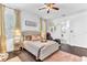 Inviting bedroom features a neutral color palette, plantation shutters, and elegant furnishings at 2246 Rush Bay Way, Orlando, FL 32824