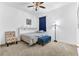 Cozy bedroom featuring neutral walls, carpet, soft bedding, and a colorful accent chair at 2246 Rush Bay Way, Orlando, FL 32824