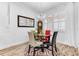 Cozy dining area featuring a modern chandelier, four chairs, and a window with plantation shutters at 2246 Rush Bay Way, Orlando, FL 32824