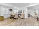 Inviting dining room with wood-look tile, stylish furnishings, large windows, and an open view to the living areas at 2246 Rush Bay Way, Orlando, FL 32824