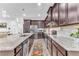 Well-equipped kitchen boasts dark cabinets, granite countertops, stainless appliances, and a subway tile backsplash at 2246 Rush Bay Way, Orlando, FL 32824