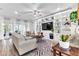 Spacious living room featuring built-in shelving, stylish decor, comfortable seating, and natural light from large windows at 2246 Rush Bay Way, Orlando, FL 32824