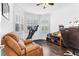 Bright home office with hardwood flooring, large windows with plantation shutters, and comfortable seating for a productive workspace at 2246 Rush Bay Way, Orlando, FL 32824