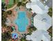 An aerial image displaying a large community pool with ample seating, umbrellas and well manicured grounds around the club house at 2318 Silver Palm Dr, Kissimmee, FL 34747