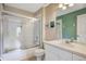 Clean bathroom featuring a shower-tub combo with a glass screen and a sink vanity at 2318 Silver Palm Dr, Kissimmee, FL 34747