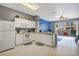 Bright kitchen featuring white cabinets, granite countertops, and access to the pool patio at 2318 Silver Palm Dr, Kissimmee, FL 34747