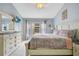 Serene main bedroom with tile floors, a large dresser and TV, and decorative accents at 2318 Silver Palm Dr, Kissimmee, FL 34747