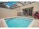 Inviting outdoor swimming pool with a protective safety fence and relaxing patio area at 2318 Silver Palm Dr, Kissimmee, FL 34747