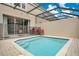 Private outdoor swimming pool with a screened enclosure and patio furniture at 2318 Silver Palm Dr, Kissimmee, FL 34747