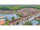 Stunning aerial view of the community featuring a lake, clubhouse, pool, and tennis courts at 2647 Corvette Ln, Kissimmee, FL 34746