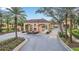 The gated community features lush landscaping and mature palm trees at 2647 Corvette Ln, Kissimmee, FL 34746