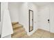 Bright hallway with staircase, neutral tiling and freshly painted white walls at 2647 Corvette Ln, Kissimmee, FL 34746