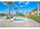 Inviting hot tub with a lift for easy access and lush landscaping, with waterslides in the background at 2647 Corvette Ln, Kissimmee, FL 34746