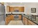 Kitchen featuring stainless steel appliances, granite counters and wood cabinets at 2647 Corvette Ln, Kissimmee, FL 34746