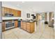 Well-lit kitchen and dining area with stainless steel appliances and access to the outdoor patio at 2647 Corvette Ln, Kissimmee, FL 34746