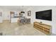 Open concept living and dining area with kitchen access and mounted television at 2647 Corvette Ln, Kissimmee, FL 34746