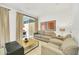 A comfortable seating area near the patio doors that invite the sunlight inside at 2647 Corvette Ln, Kissimmee, FL 34746