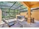 Screened patio features a hot tub, table with chairs, and lounge chairs at 2647 Corvette Ln, Kissimmee, FL 34746