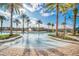 Resort-style pool area with palm trees, lounge chairs, and a fountain at 2647 Corvette Ln, Kissimmee, FL 34746