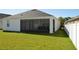 Beautiful backyard featuring a screen lanai and green lawn at 2657 Youngford St, Orlando, FL 32824