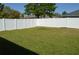 Backyard featuring green grass and a white privacy fence at 2657 Youngford St, Orlando, FL 32824