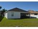 Home's exterior featuring a green lawn and screened lanai for outdoor enjoyment at 2657 Youngford St, Orlando, FL 32824