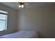 Bedroom featuring a ceiling fan, a window with blinds, and a bed with white comforter at 2657 Youngford St, Orlando, FL 32824