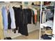 Walk-in closet with a variety of clothing items and shelving at 2657 Youngford St, Orlando, FL 32824