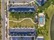 Overhead view of community featuring townhomes, lush landscaping, and a sparkling pool at 2925 Caribbean Soul Dr, Kissimmee, FL 34747