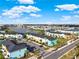 Aerial view of a vibrant community with colorful townhomes and a picturesque lake at 2925 Caribbean Soul Dr, Kissimmee, FL 34747