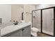 Modern bathroom with a gray vanity, tile floors, and glass shower door at 2925 Caribbean Soul Dr, Kissimmee, FL 34747