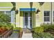 Close-up of a Caribbean Dream home's entrance, showcasing the vibrant colors and lush landscaping at 2925 Caribbean Soul Dr, Kissimmee, FL 34747