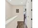 A hallway with neutral walls, wood floors and view to the front door at 2925 Caribbean Soul Dr, Kissimmee, FL 34747