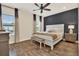 Comfortable main bedroom featuring wood floors, a ceiling fan, and a blue accent wall at 2925 Caribbean Soul Dr, Kissimmee, FL 34747