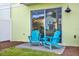 Charming patio with blue Adirondack chairs, perfect for outdoor relaxation at 2925 Caribbean Soul Dr, Kissimmee, FL 34747