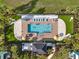 Aerial view of the community pool featuring lounge chairs, umbrellas and manicured landscaping at 2925 Caribbean Soul Dr, Kissimmee, FL 34747