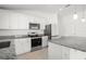 Modern kitchen featuring granite countertops, stainless steel appliances, and white cabinetry at 3201 Sweet Acres Pl, St Cloud, FL 34772