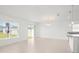 Living area features tile flooring, a modern chandelier, and sliding doors to the backyard at 3201 Sweet Acres Pl, St Cloud, FL 34772