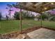 Expansive backyard featuring a large lawn, wooden beams, mature trees, and a utility shed at 4086 Biscayne Ct, Casselberry, FL 32707