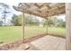 Inviting backyard patio with a wooden pergola, stone tile flooring, and a view of the spacious lawn at 4086 Biscayne Ct, Casselberry, FL 32707