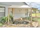 Charming backyard pond with a small waterfall feature, surrounded by lush landscaping and a decorative pergola at 4086 Biscayne Ct, Casselberry, FL 32707