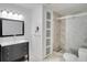 Modern bathroom featuring a dark vanity, framed mirror, and a glass-enclosed shower at 4086 Biscayne Ct, Casselberry, FL 32707