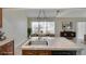 Kitchen island featuring granite countertop and dark-wood cabinets at 4086 Biscayne Ct, Casselberry, FL 32707