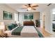 Serene main bedroom with modern decor, hardwood floors, and a view into the en-suite bathroom at 4086 Biscayne Ct, Casselberry, FL 32707