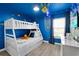 Bunk bedroom designed with ocean theme, complete with surfboard decor at 4431 Le Reve Ct, Kissimmee, FL 34746